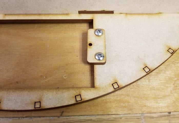 laser cut wooden tabs to hold the battery pack