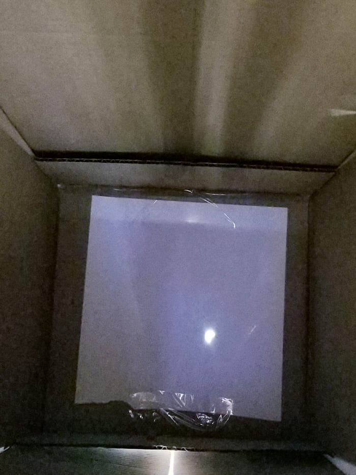 Inside the cardboard box showing the start of the solar ecplipse